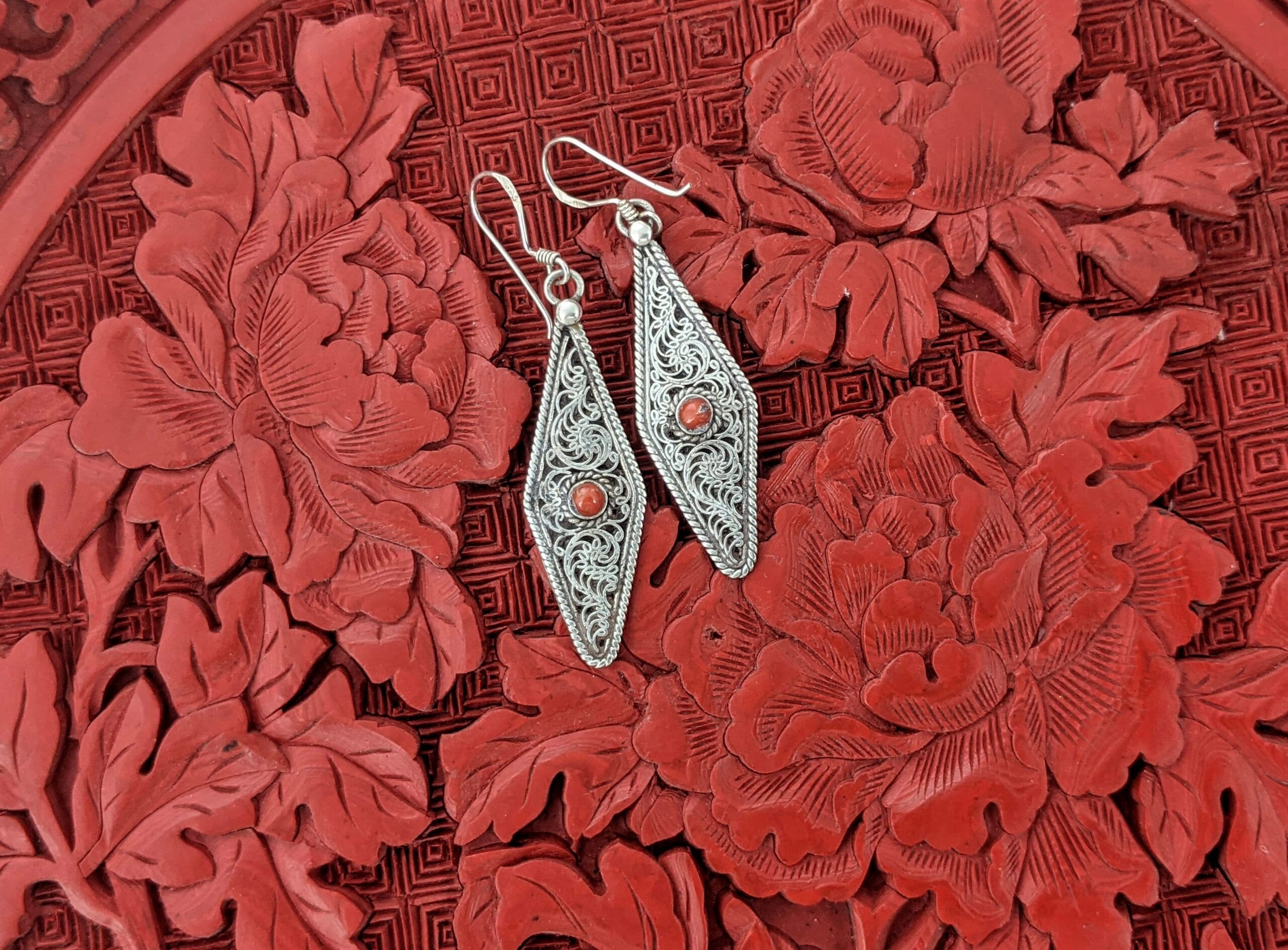 Polygon filigree earrings in sterling silver with coral accent.