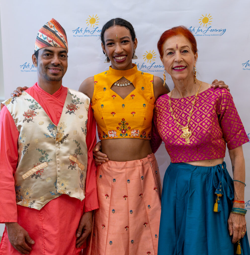 Three dancers of Utpalasia in costume at an Asian cultural dance program.