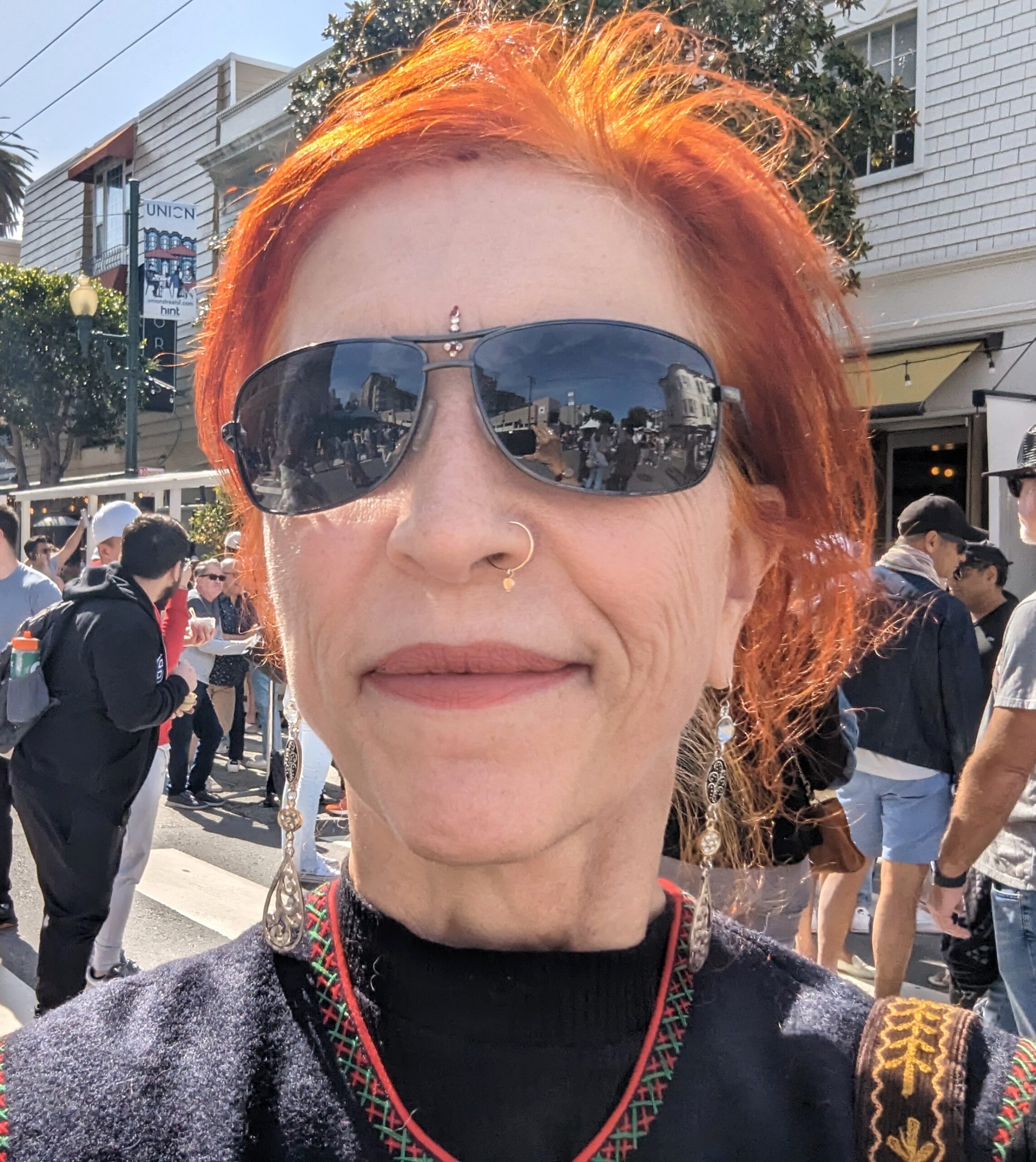 Woman with red hair at cultural street fair in San Francisco.