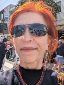 Woman with red hair at cultural street fair in San Francisco.