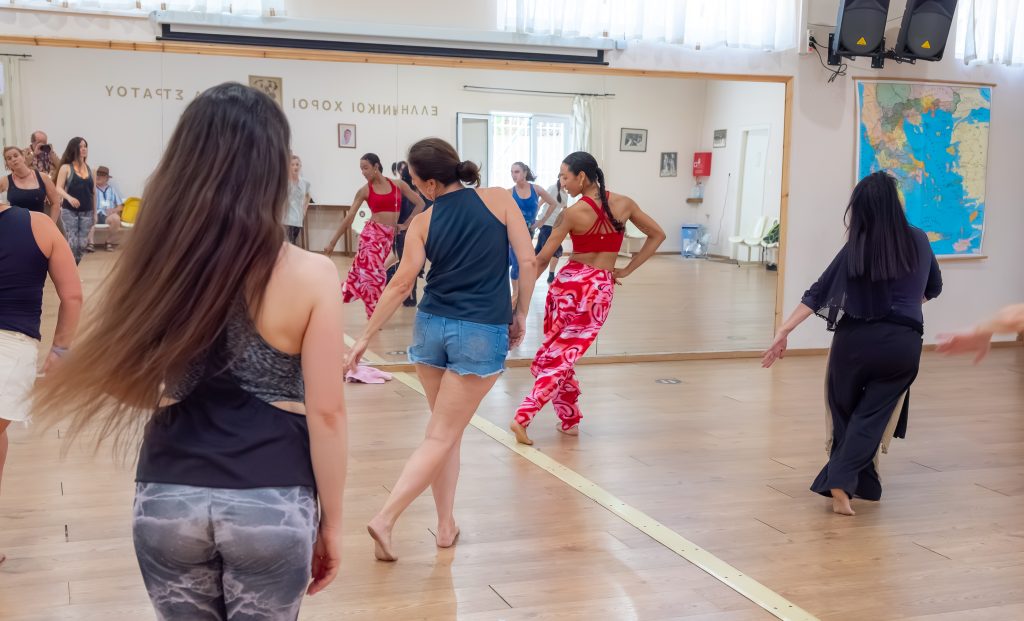 Girl in pink leading a dance fitness class