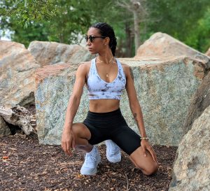 Girl in fitness costume in the park.